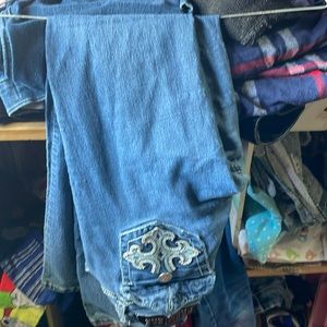 Blue flared jeans lowrise with cross on pockets